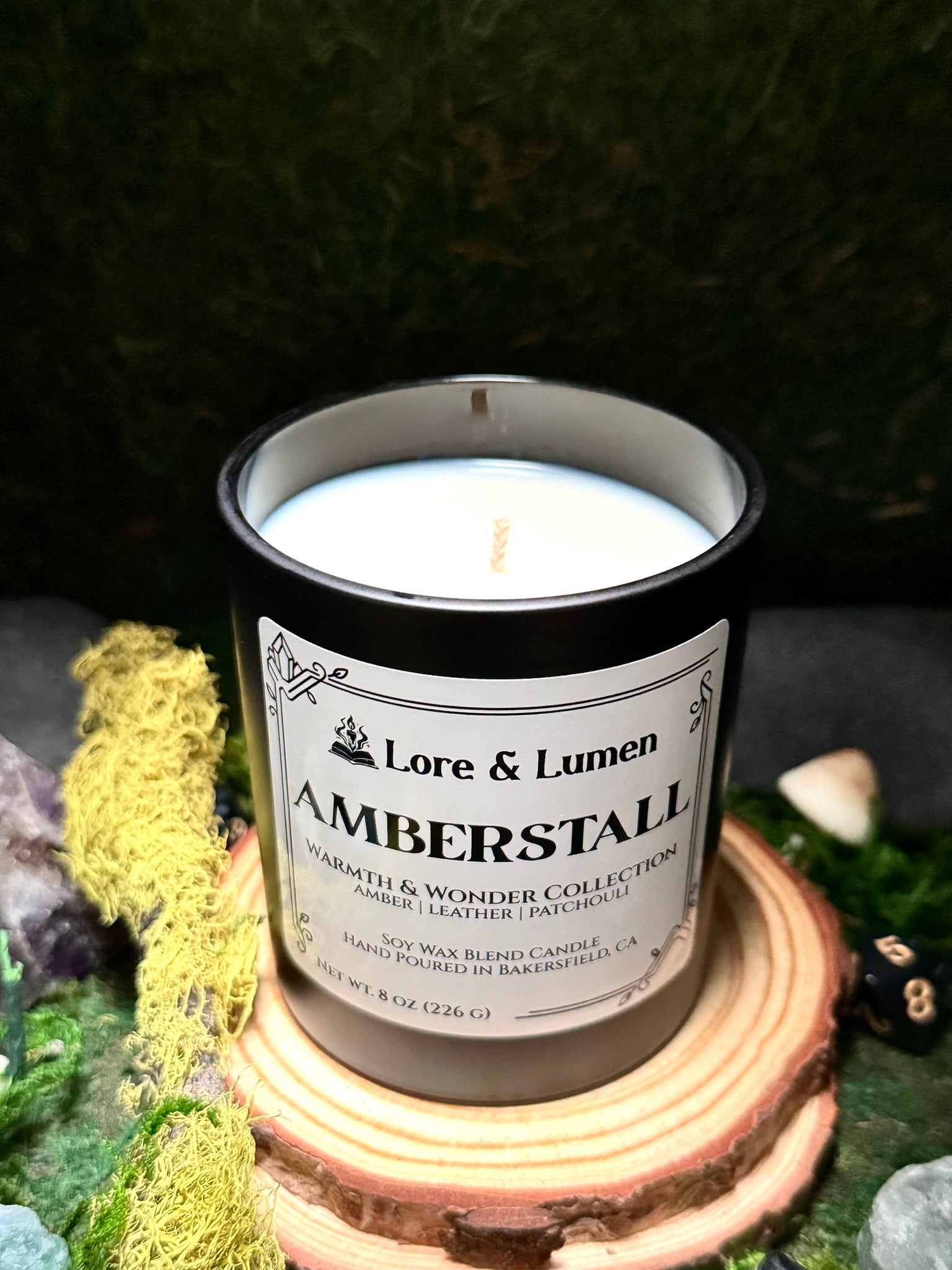 Amberstall fantasy candle with notes of vanilla and patchouli, styled for fantasy market scenes.