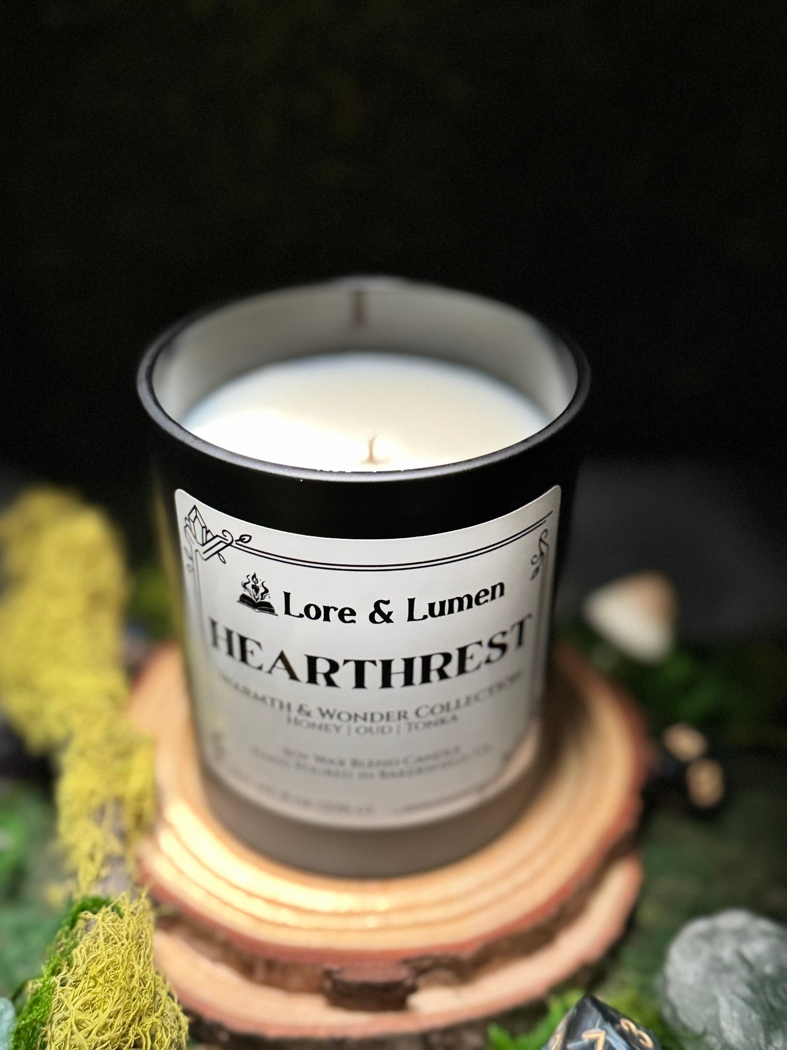 Hearthrest fantasy candle with notes of honey, oud, and tonka, styled for post-quest relaxation scenes.