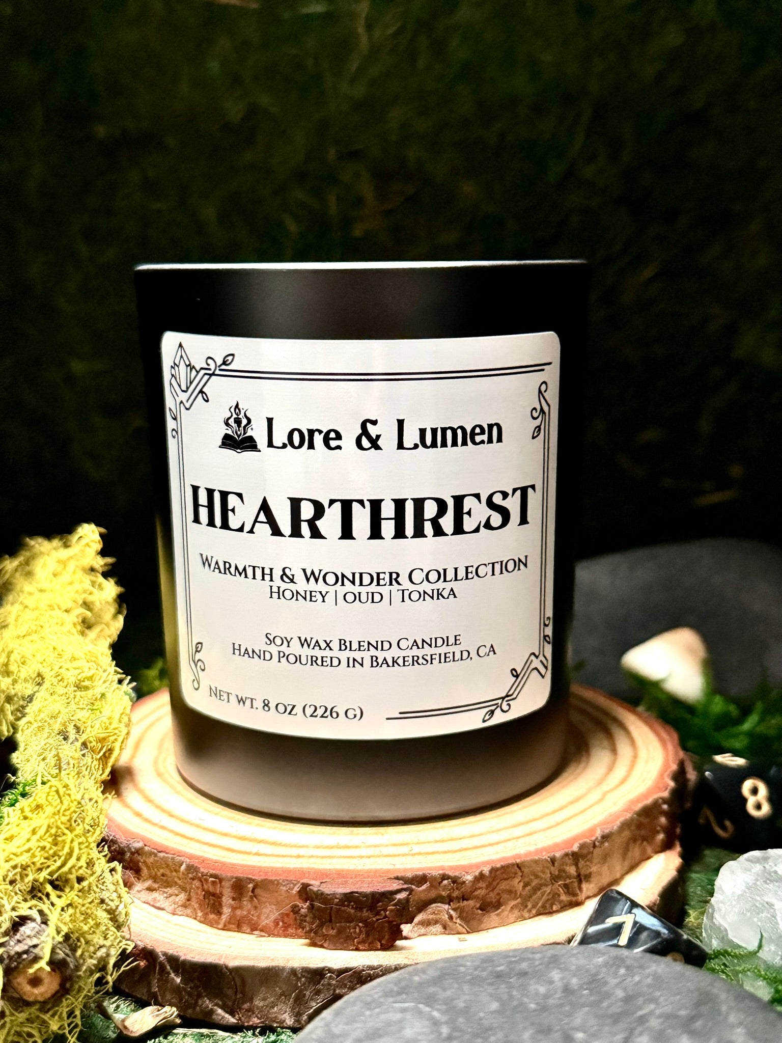 Hearthrest fantasy candle with notes of honey, oud, and tonka, styled for post-quest relaxation scenes.